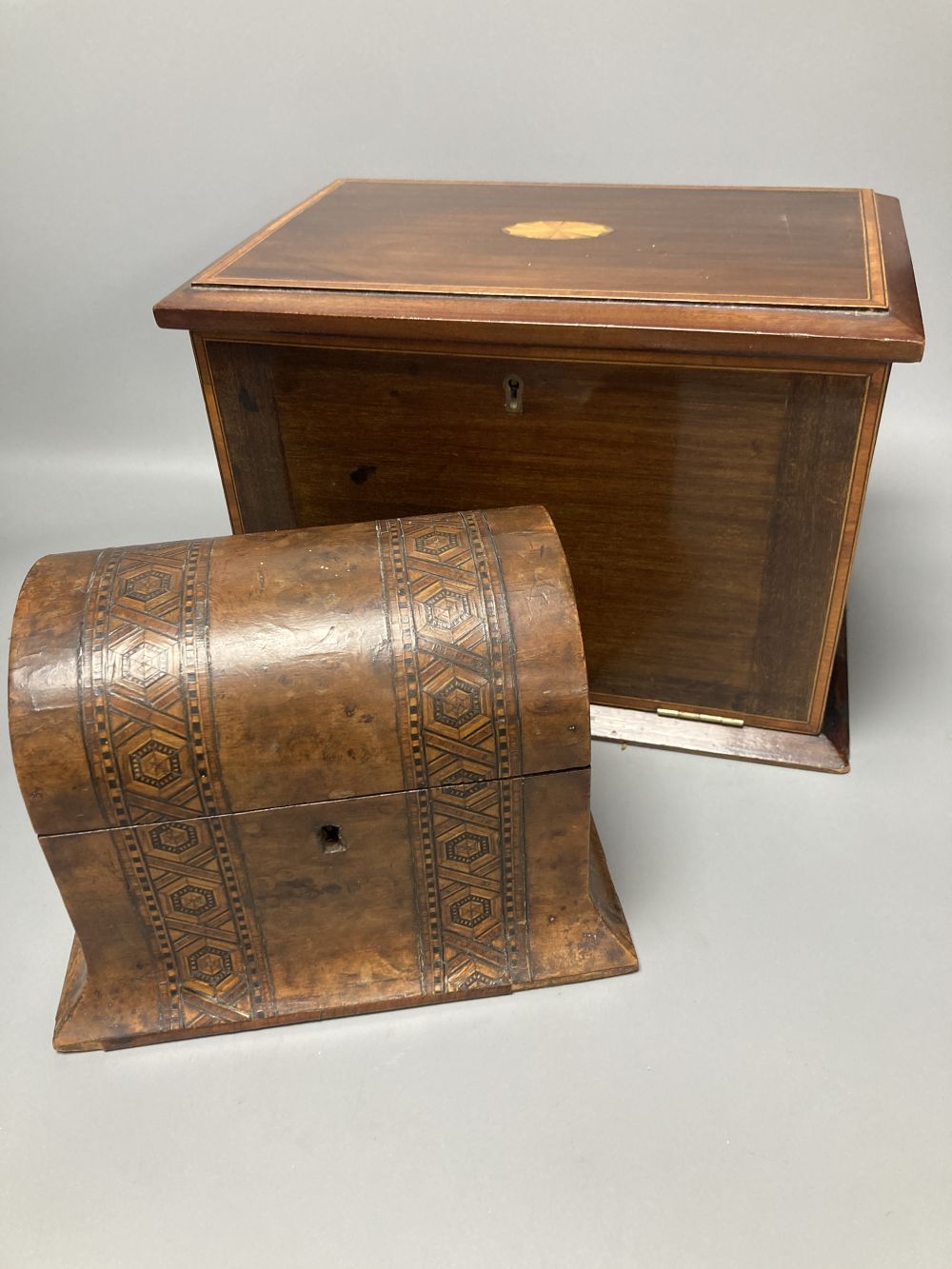 An Edwardian inlaid mahogany writing box, with hinged folding slope and fittings, 29cm, and a Victorian walnut and parquetry tea caddy,